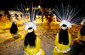 Women in straw dresses dancing local folkloric dance for a festival. Tahiti. French Polynesia