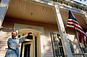 Patriotic woman by her house. New Orleans. Louisiana. United states (USA)