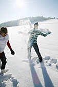 Two women snowball fighting, Styria, Austria