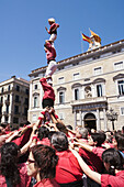 Castellers (human towers builders, a Catalan tradition) in Plaça de Sant Jaume, Barcelona. Catalonia, Spain