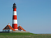 Lighthouse, salt meadow, tide. Westerhever, Schleswig-Holstein Wadden Sea National Park, Germany