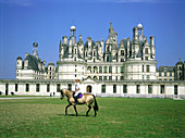 Horsewoman in front of Chambord Castle. Val-de-Loire. France