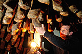 Jean Raffalli taking care of his drying local sausages and hams. Piedicroce. Corsica island. France