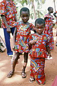 Two small sisters dressed for a dance festival. Assinie. Ivory Coast