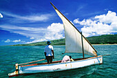 Local fishing boat under sail in the lagoon. Rodrigue island. Mauritius