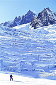 Lonesome skier in a trail with the seracs glacier in background. Vallee Blanche. Chamonix. Haute-Savoie. Alps. France