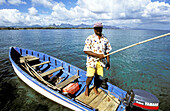 Fisherman on his local small fishing boat. Trou-Aux-Biches. South West. Mauritius