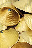 Straw hats on a small boat. Damnoen Saduak Floating Market. Bangkok. Thailand