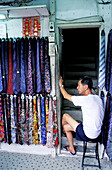 Shopkeeper selling ties at market. Wanchai, Hong Kong. China