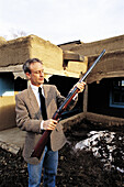 Curator of local museum holding scout Christopher Kit Carson s last gun. Taos, New Mexico. USA