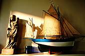 Scale model of local ancient fishing boat and Virgin statue. Cancale. Ille-et-Villaine. Brittany. France