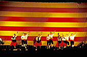 Dancing Sardanes , traditional catalan dance and catalan flag in background. Saint John Festival. Perpignan. Pyrenees-Orientales. Languedoc Roussillon. France