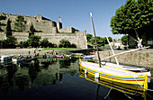 Traditional Catalan boats and Royal Castle in background. Historic Village and Harbour. Colliure. Pyrenees-Orientales. Languedoc Roussillon. France