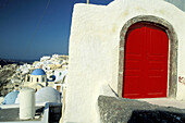 Red door and blue church belfries. Ia village. Santorini (Cyclades). Greece