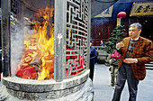 Intimate ceremony for grandfather s death first anniversary at the Jade Buddha temple. Shanghai. China