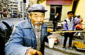 Beggar, street scene in the old town. Shanghai. China
