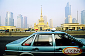 Cab on a city freeway, british colonial building and skyscapers at back. Shanghai. China