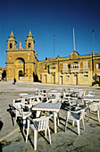 Café terrace on the Church Square. Marsaxlokk. Malta.
