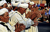 Traditional Berber dances performed by men during the summer festival. Marrakech. Morocco.