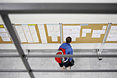 Student looking at notice board. Escuela Universitaria Politecnica, UPV (Universidad del Pais Vasco), Campus de Gipuzkoa. San Sebastián, Euskadi, Spain