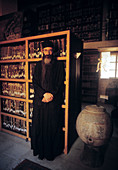 Monk of St. Catherine s Greek Orthodox monastery in the library. Sinai desert, Egypt