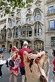 Tourists in front of Casa Batlló art nouveau house by Gaudí, Barcelona. Catalonia, Spain
