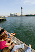 People at Port Vell with World Trade Center in background, Barcelona. Catalonia, Spain