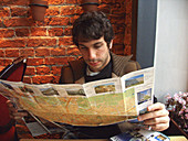 Russia, Moscow, Abe Nowitz in restuarant, reading map. (MR)