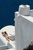 Santorini, Greece, a woman tanning in the villge of Oia.