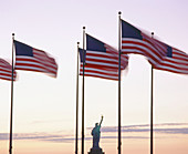 USA flags and Statue of Liberty. New York. USA