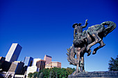 Cowboy statue, Civic center &downtown skyline, Denver, Colorado, USA.