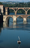 Barge with tourists on Tarn river and Pont Vieux bridge (11th century), Albi. Tarn, France