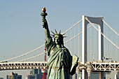 Statue of Liberty replica and Rainbow Bridge at Odaiba district. Tokyo. Japan