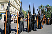 Nazarenos (penitents) of Fratenidad de los Estudiantes at the Holy Week. Sevilla. Andalusia, Spain