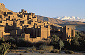 The world-famous kasbahs ( fortress) at Aït Benhaddou are under the auspices of the UNESCO. In the background the snow-capped High Atlas mountains. Southern Morocco.