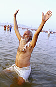 Pilgrims bathing at Sangam, the confluence of the three rivers. Kumbh Mela, Allahabad. River Ganges. India.