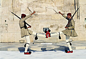 Soldiers ( evzones ) on guard at the Monument to the Unknown Soldier and Parliament (Royal Palace), Syntagma Square, Athens. Greece
