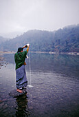 Woman offering a pooja to the Ganges, Rishikesh. Uttaranchal, India