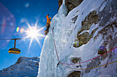 Man ice climbing at Corn Diavolezza (man-made icefall), Pontresina, Upper Engadin, Grisons, Switzerland