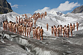 A group of naked people in front of an ice crevasse, around 600 people are posing for Spencer Tunick and Greenpeace on the Aletsch Glacier to protest about climate change, Aletsch Glacier, Valais, Switzerland