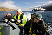 Tourists and seaman in an inflatable rubber boat, Hermaness, island of Unst, Shetland islands, Scotland, UK, Tourists
