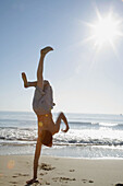 Virginia Beach, Virginia, USA, boy playing on the beach, 13 years old.