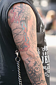 Punk with tatoos of violence on arm, Amsterdam, Holland, Netherlands