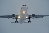 Jet aircraft on final approach, during snowstorm at night,Montreal Quebec Canada