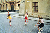 Little girls playing in the street. Lviv. Ukraine