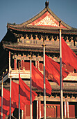 Zhongyang Tower and red flags. Tiananmen Square, Qianmen (Front Gate). Beijing. China