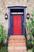 Red door and prickly pear cactus in Presidio historic district. Tucson. Arizona, USA