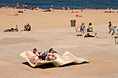 Spain Barcelona beach Platja de la Barceloneta, curved seats for sunbathing