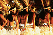 Women in straw dresses dancing local folkloric dance for a festival. Tahiti. French Polynesia
