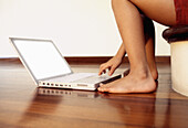  Barefeet, Barefoot, Child, Children, Color, Colour, Computer, Computers, Contemporary, Floor, Floors, Horizontal, Human, Indoor, Indoors, Interior, Kid, Kids, Laptop, Laptops, Leg, Legs, One, One person, Parquet, People, Person, Persons, Portable compute
